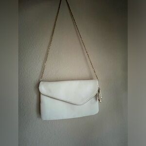 Lulus white crossbody bag/ clutch with gold details.